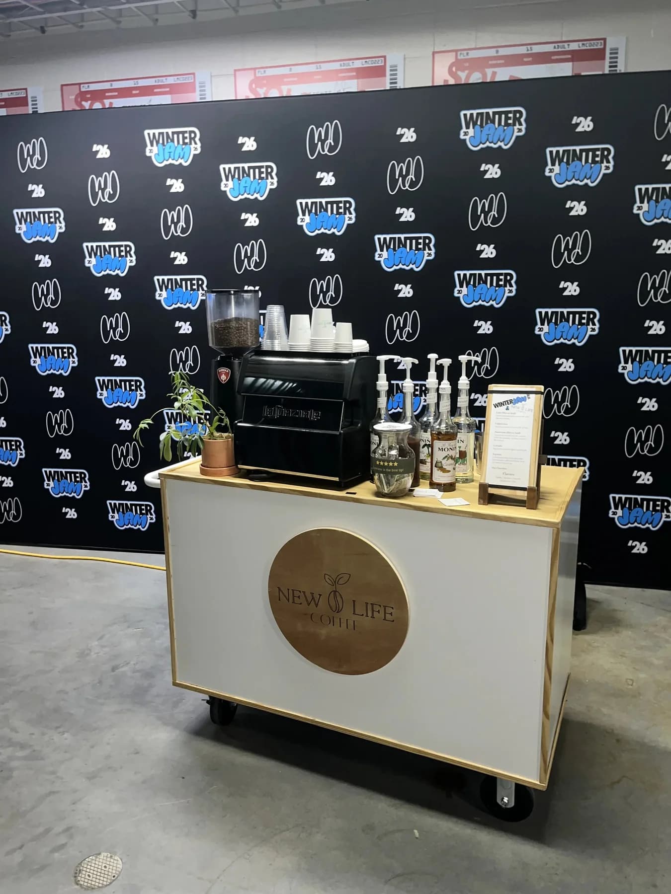 New Life Coffee Company barista serving guests at a catered coffee cart