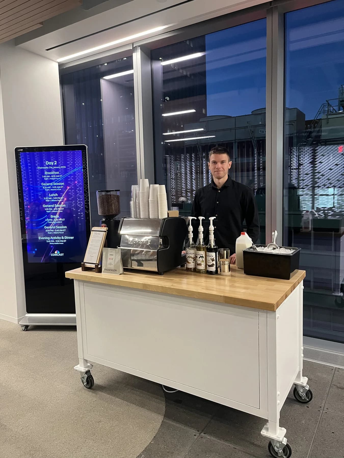 Mobile espresso bar set up beside a digital display in a Philadelphia office tower lobby