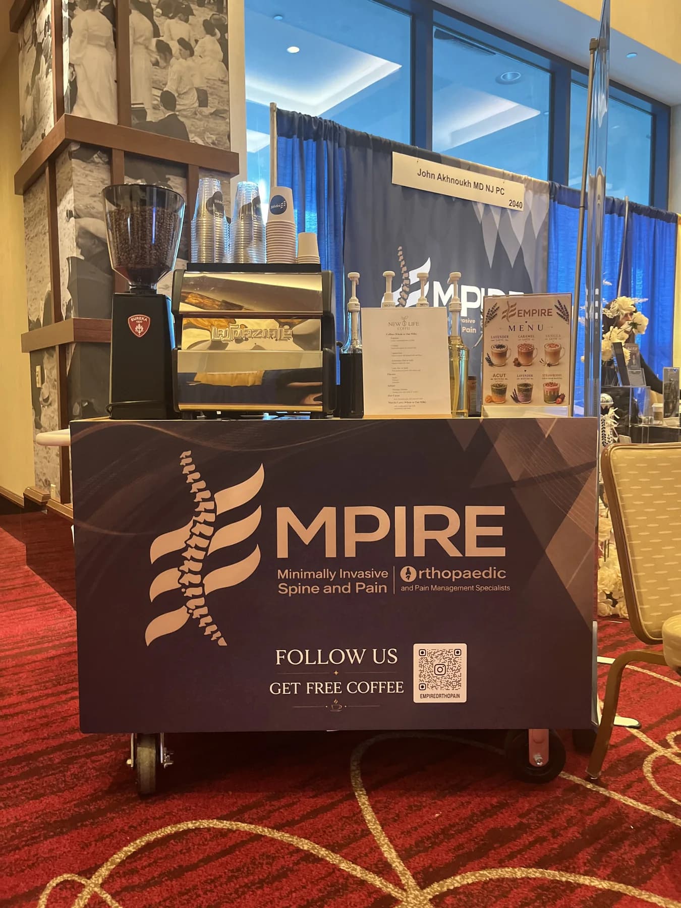 Branded New Life Coffee Company espresso cart serving guests at a conference expo booth