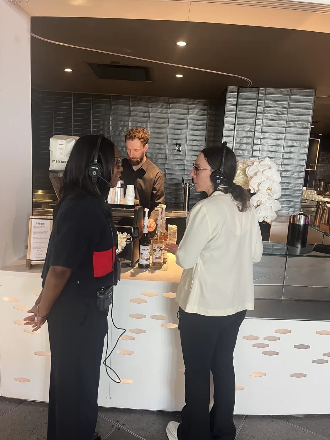 Employees gathered around a New Life Coffee Company cart at a corporate event