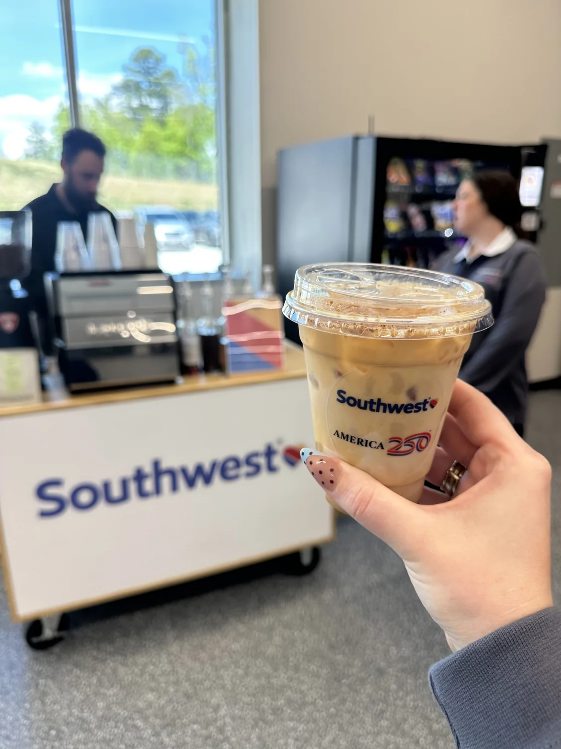 Guest holding an iced coffee at a Southwest Airlines branded coffee activation