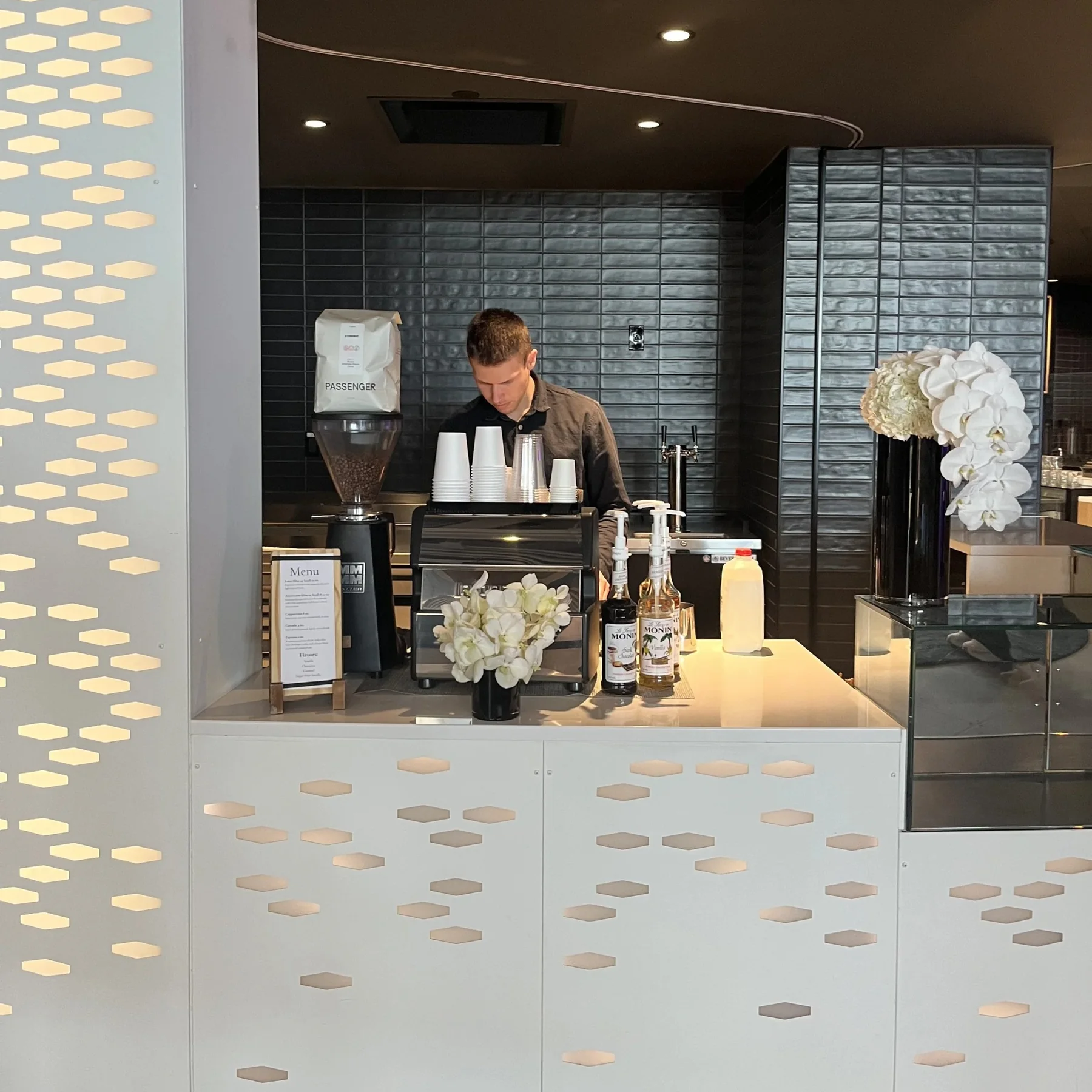 New Life Coffee Company espresso bar styled with white florals inside an upscale Philadelphia event venue